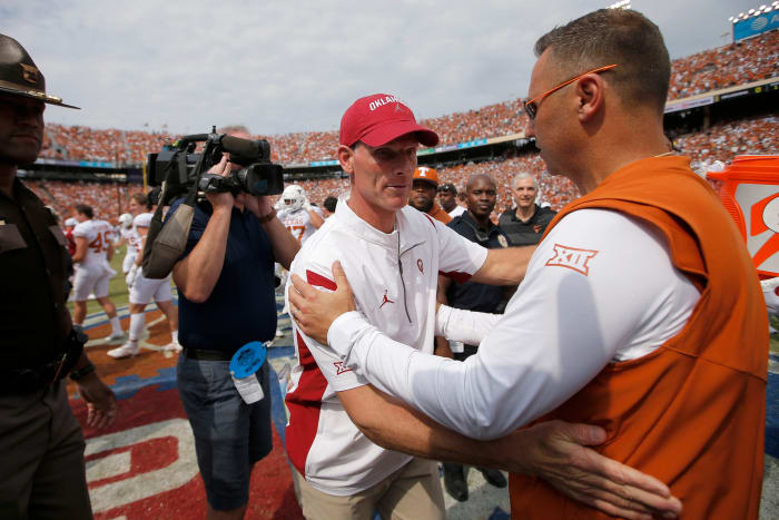 Oklahoma Sooners head coach Brent Venables, left, and Texas Longhorns head coach Steve Sarkisian meet after the Red River Showdown college football game between the University of Oklahoma (OU) and Texas at the Cotton Bowl in Dallas, Saturday, Oct. 8, 2022. Texas won 49-0.